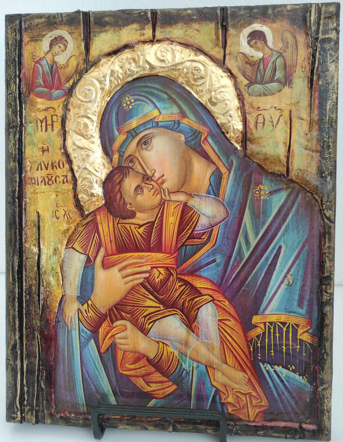 An antique-style wooden religious icon design depicting the Holy Family, mounted on a dark wooden panel with a metal hanger on the right side.