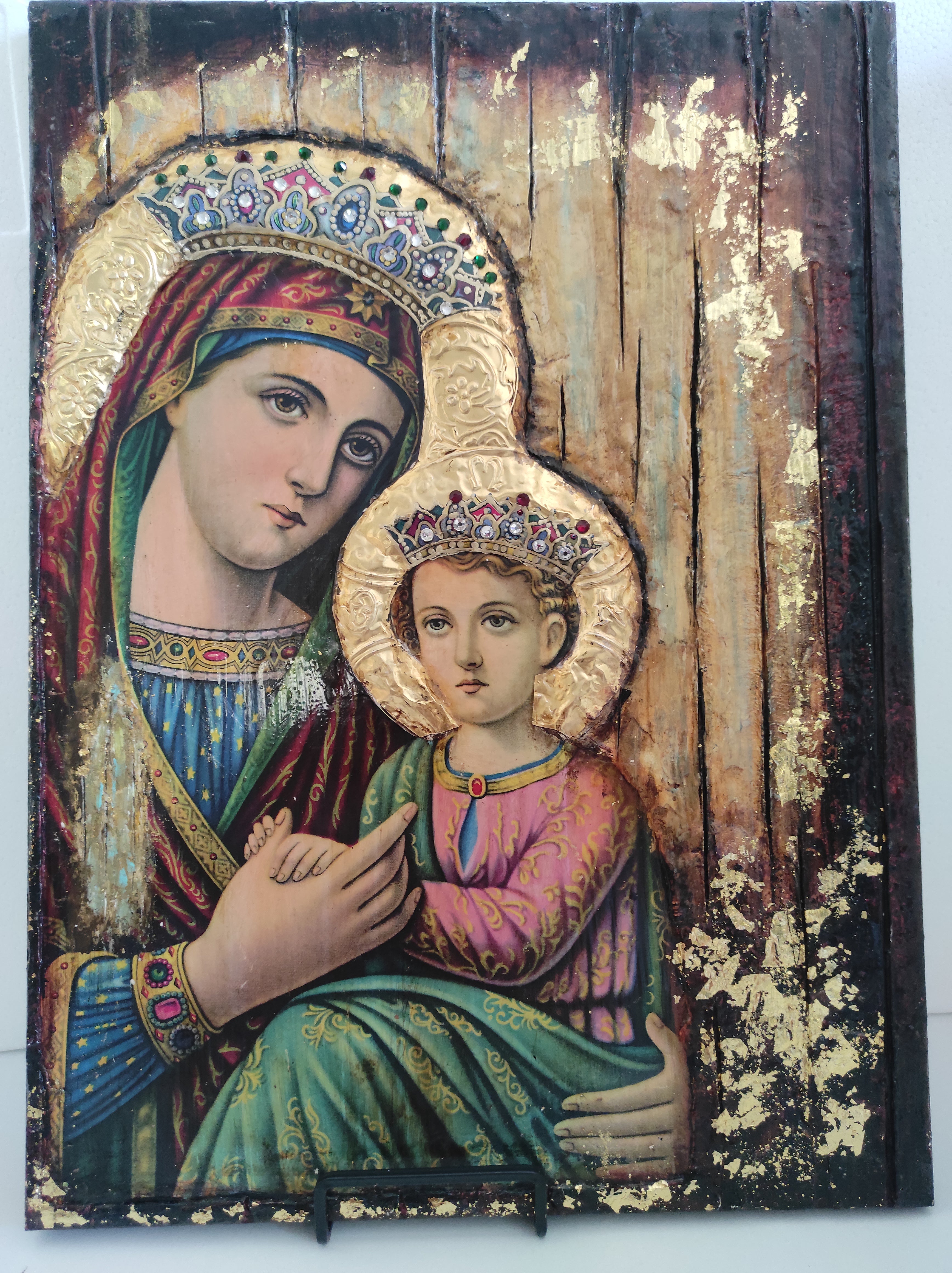 Decorative painting of two figures with intricate details on a wooden background