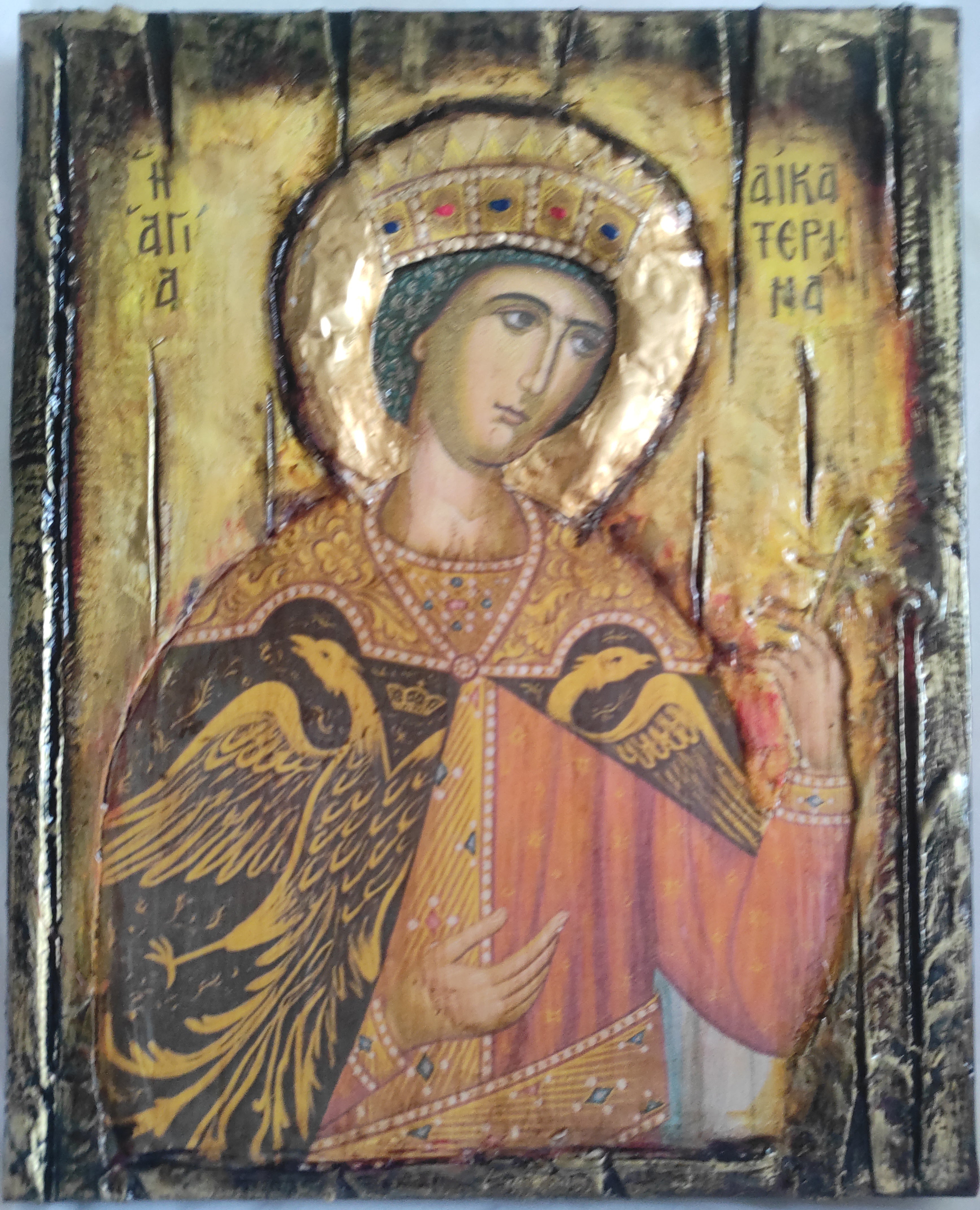 An antique-style religious icon of the Virgin Mary with a gold leaf halo and ornate gold and red garments, shown against a light gray background.