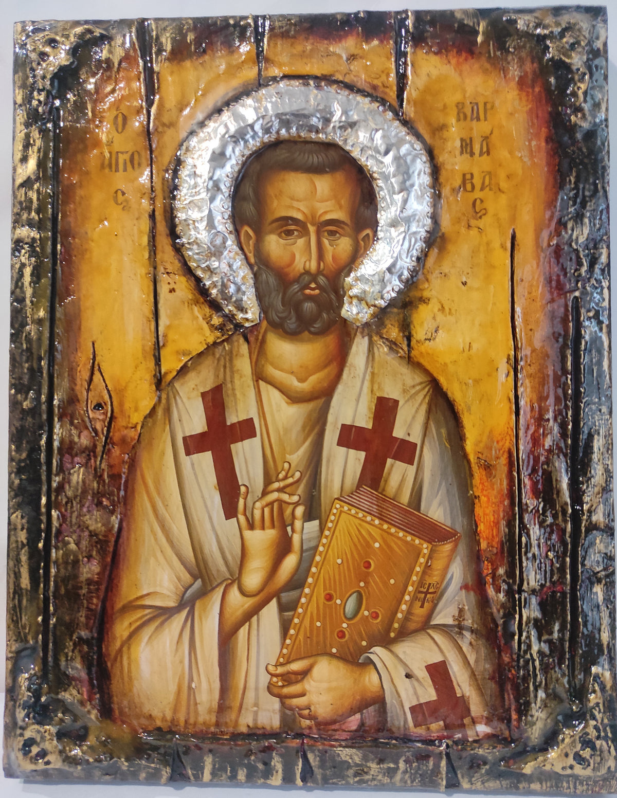 An antique-style religious icon design of Saint Varnavas on a distressed wooden panel with gold, brown, red, and silver tones.