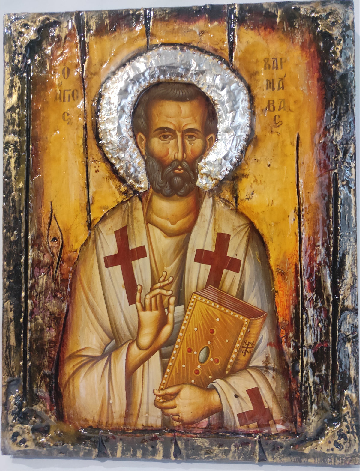 An antique-style religious icon design of Saint Varnavas holding a book, featuring a textured gold background, silver foil halo, and distressed dark border.
