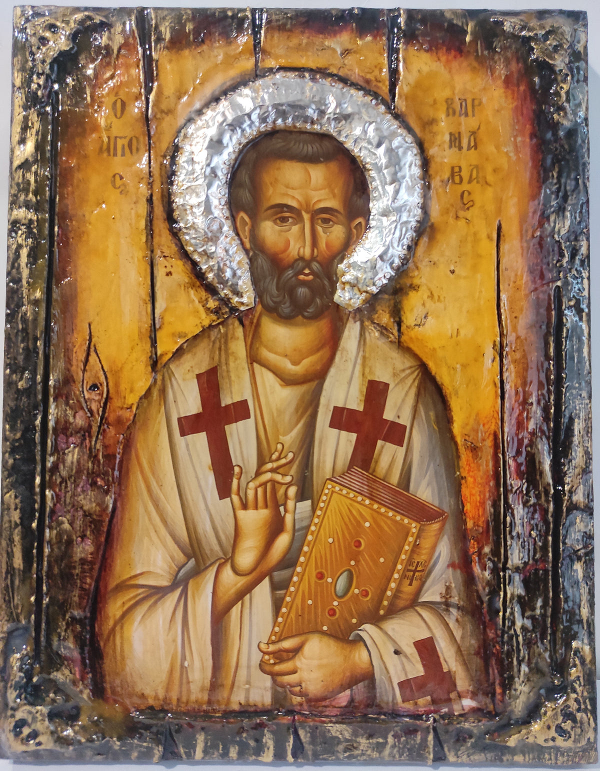 An antique-style religious icon design of Saint Varnavas holding a book, featuring a textured gold background, silver foil halo, and distressed dark border.