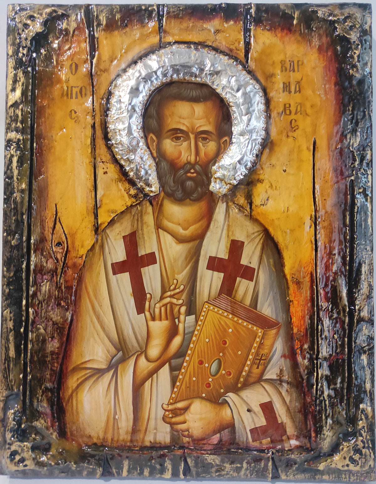 An antique-style religious icon design of Saint Varnavas Barnabas on a distressed wooden panel with a metallic silver foil halo.