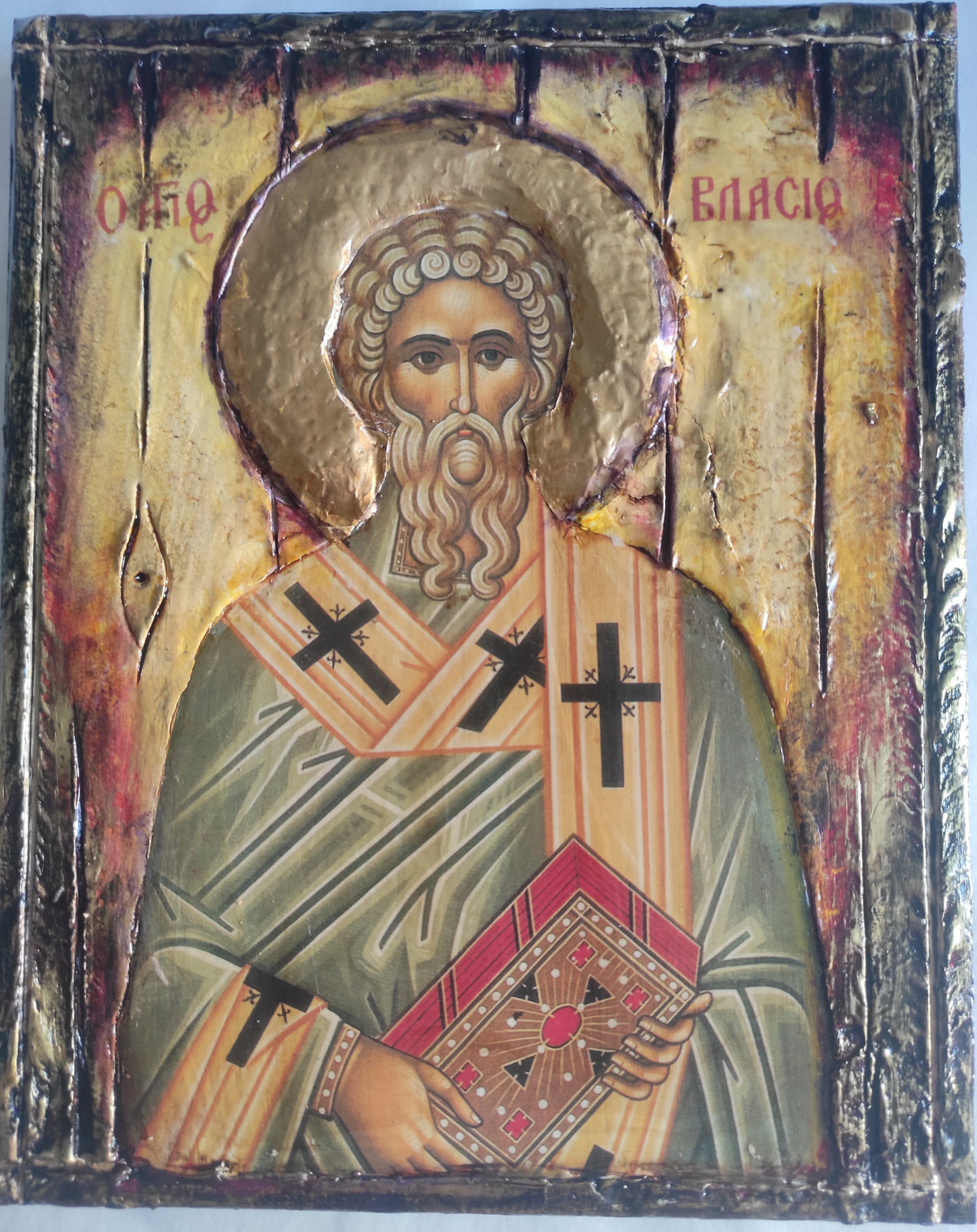 A traditional religious icon design of Saint Basil on a wooden panel, featuring gold leaf, distressed wood, and painted details.